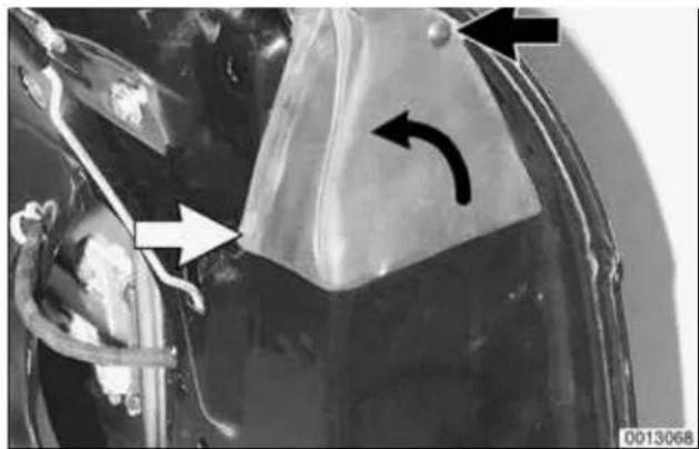 Close-up of a mechanical component with directional arrows and a curved arrow indicating motion (no text or symbols)
