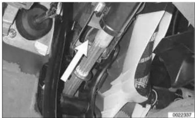 Close-up of mechanical components with a white arrow pointing to a component (no visible text or symbols)