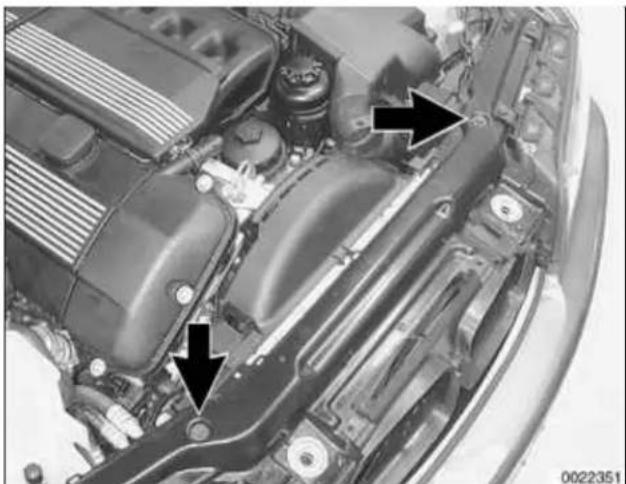 Close-up of a car engine bay with black arrows pointing to internal components (no visible text or symbols)