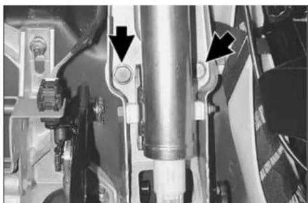 Close-up mechanical assembly showing a cylindrical component with two black arrows pointing to specific parts (no visible text or symbols)