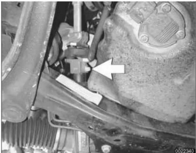 Close-up of a mechanical component with visible parts and an arrow pointing to a specific part (no text or symbols present)