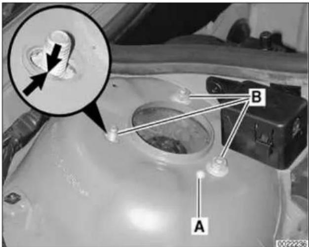 Technical diagram of a vehicle engine component with labeled parts A and B, showing a magnified view of a component with an arrow pointing to part B.