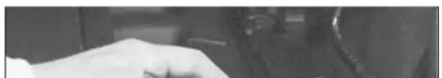 Close-up of a hand resting on a surface, possibly part of a device or device (no visible text or symbols)