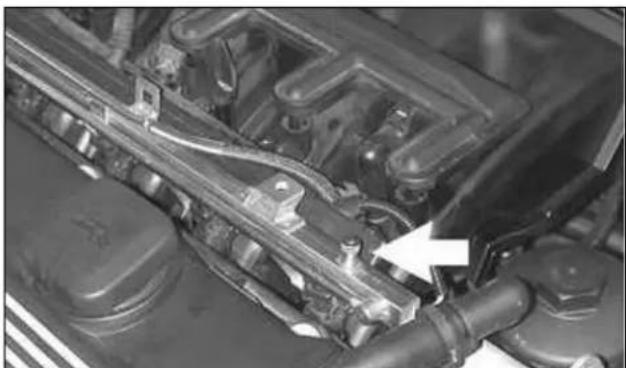 Close-up of an engine cylinder assembly with visible valve and shaft (no text or symbols)