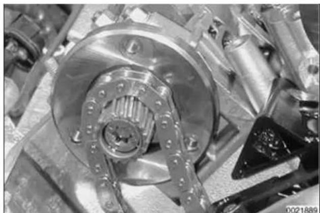 Close-up of mechanical components including a metallic gear and flanged shaft (no visible text or symbols)