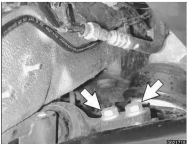Close-up of a mechanical component with visible wiring and two white arrows pointing to features (no text or symbols)