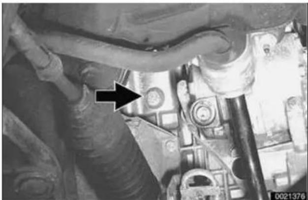 Close-up of mechanical components with a black arrow pointing to a specific part (no visible text or symbols)