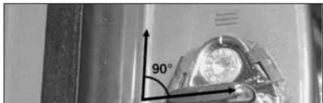 Close-up of a mechanical component with a 90-degree angle indicator (no text or symbols on the object itself)