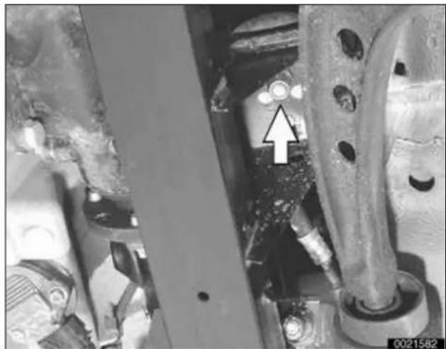 Close-up of mechanical components with a white arrow pointing to a specific feature (no visible text or symbols)