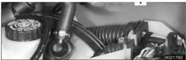 Close-up of automotive engine components including hoses and a valve (no visible text or symbols)