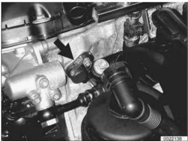 Close-up of an engine component with visible hoses and valve assembly (no text or symbols)