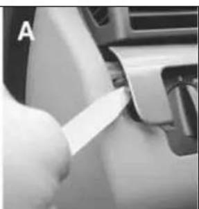 Close-up of a hand inserting a plastic clip into a car compartment (no visible text or symbols)