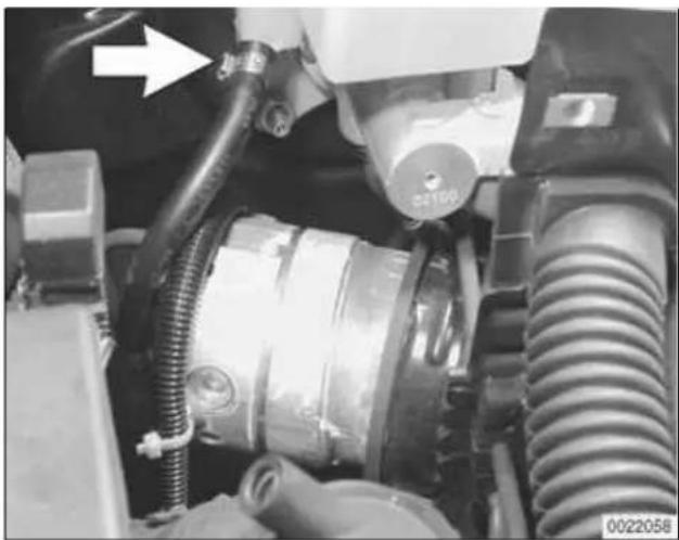 Close-up of a mechanical assembly with hoses and components, no visible text or symbols