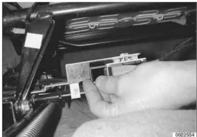 Close-up of a hand inserting a small electronic component into a mechanical housing (no visible text or symbols)
