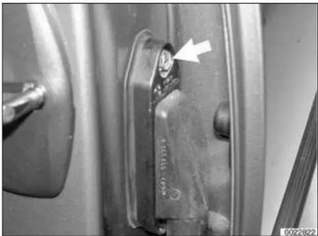 Close-up of a car door handle with a white arrow pointing to a component, no visible text or symbols