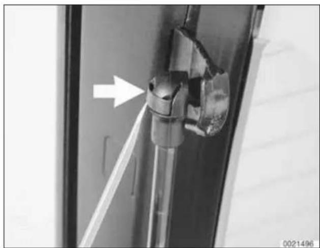Close-up of a mechanical component with an arrow pointing to a feature, no visible text or symbols