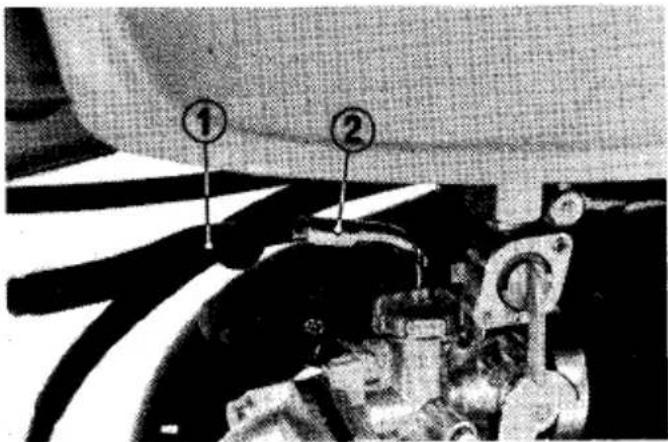 Black-and-white industrial photo showing machinery components with numbered labels ① and ②
