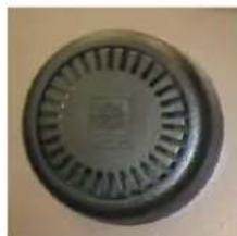 Circular mechanical component with radial grooves and a small logo on the side (no visible text or symbols)