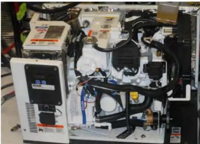 Interior view of an industrial electrical enclosure with visible wiring, valves, and control panel (no readable text or symbols)