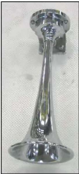 Close-up of a metallic mechanical knob or dial with a flared handle and circular top (no text or symbols visible)