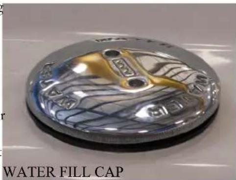 Close-up of a metallic water fill cap with engraved patterns (no text or symbols on the cap itself)