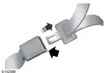 Close-up of a metallic belt buckle with two buttons and arrows indicating fastening (no text or symbols)