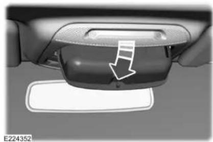 Close-up of a car interior panel with a white arrow pointing to a component, no visible text or symbols