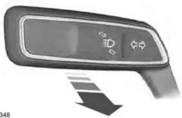 Close-up of a car dashboard with a control panel and directional arrow (no text or symbols visible)