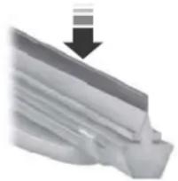 Close-up of a metallic mechanical component with a downward arrow indicating compression (no text or symbols visible)