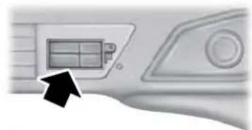 Interior view of a vehicle dashboard with a black arrow pointing to the front panel (no visible text or symbols)