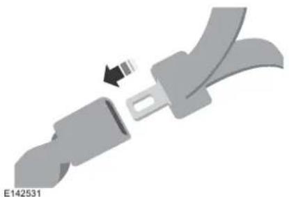 Mechanical component diagram showing a belt buckle assembly with a black arrow indicating rotation (no text or symbols)