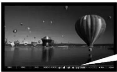 Black-and-white photo of a hot air balloon floating on water with floating bubbles and reflections (no text or symbols).