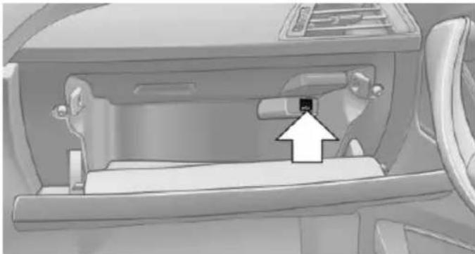 Interior view of a car showing the backrest door and seat area with an arrow pointing to a small component (no text or symbols visible)