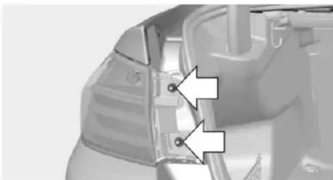 Close-up of a mechanical component with two white arrows pointing to specific features (no text or symbols visible)