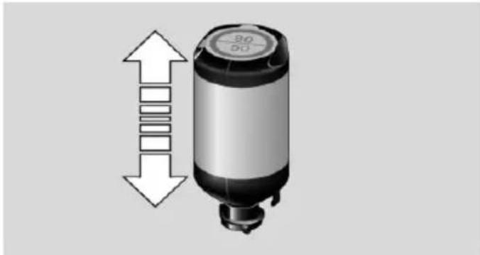 Diagram of a cylindrical device with directional arrows indicating vertical and horizontal movement (no text or symbols)