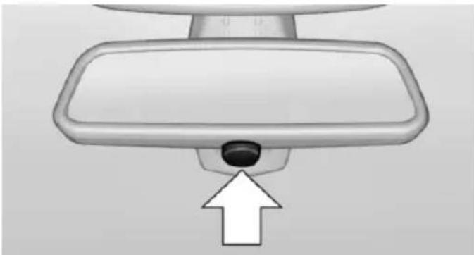 Top-down view of a car rearview mirror with a black sensor and white arrow pointing to the lens (no text or symbols)