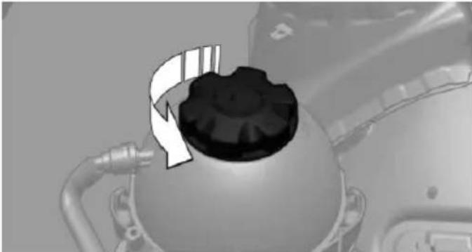 Close-up of a mechanical component with a gear-like top and pipe fittings (no visible text or symbols)