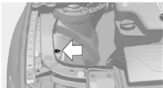 Close-up of a mechanical component with a white arrow pointing to a specific part (no visible text or symbols)