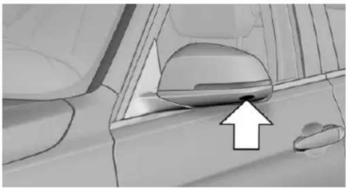 Interior view of a car showing the wheel rim and dashboard area with an arrow pointing to the nose (no text or symbols present)