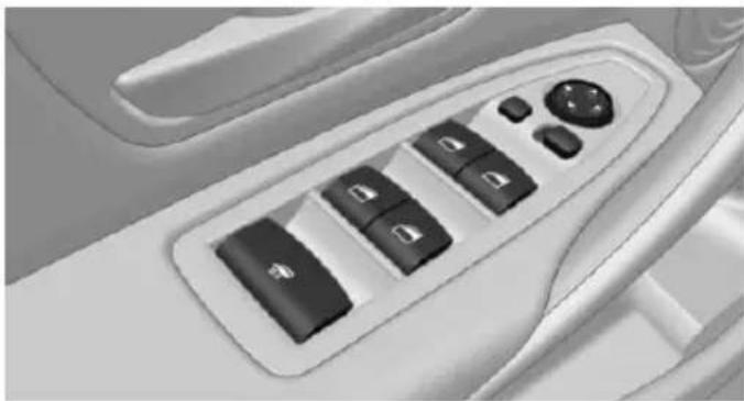 Interior view of a car dashboard with control buttons and a play button (no text or symbols visible)