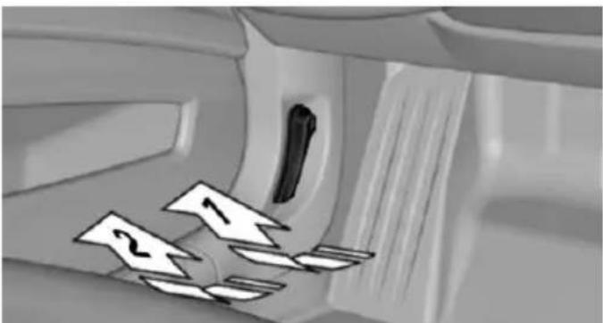 Interior view of a car showing a door, seatbelt, and directional arrows (no text or symbols)