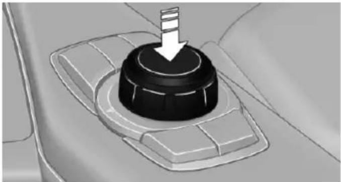 Close-up of a car's internal gear shift knob with a white arrow pointing downward (no text or symbols)