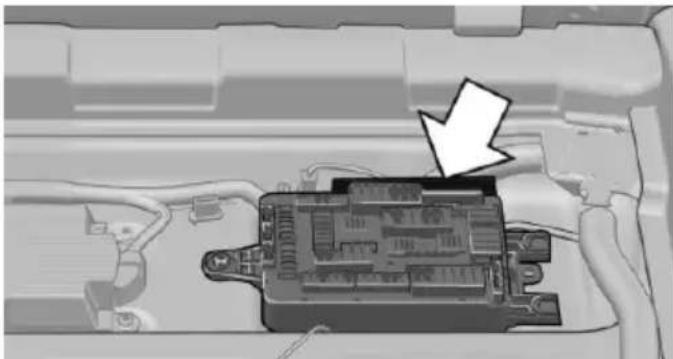 Interior view of a vehicle battery pack with an arrow pointing to the internal components (no text or symbols visible)