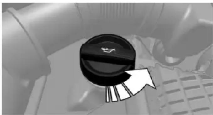 Close-up of a car dashboard knob with a white arrow pointing to the right side (no text or symbols visible)