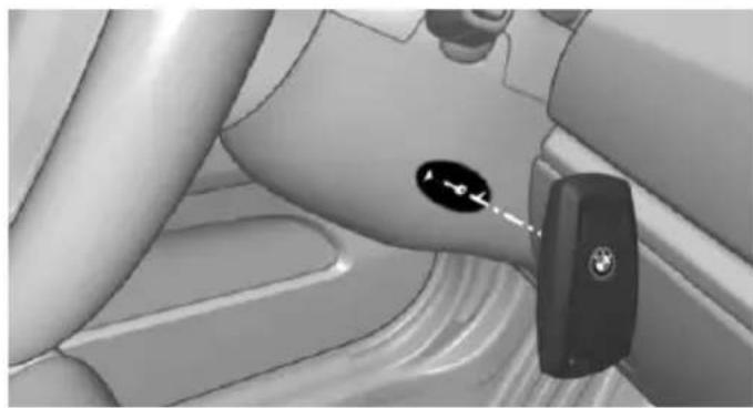 Interior view of a car seatbelt with a car key inserted, showing no text or symbols on the main subject.