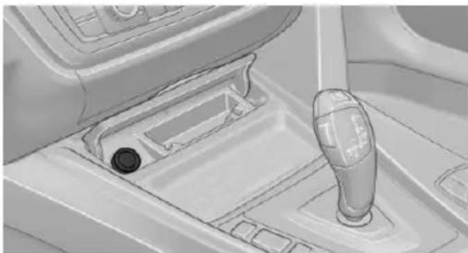 Interior view of a car gear shift lever and dashboard (no text or symbols visible)