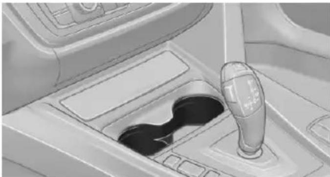 Interior view of a car gear shift lever and intake manifold (no text or symbols visible)