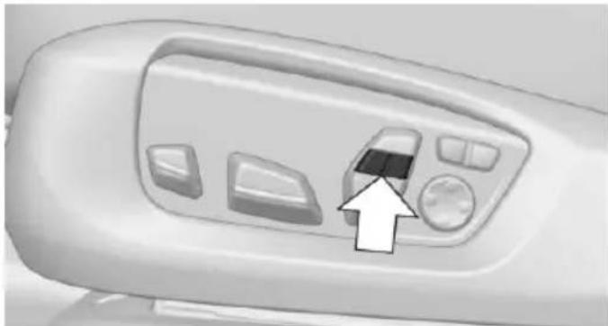 Close-up of a white industrial machine control panel with buttons and a directional arrow pointing to the button (no text or symbols visible)