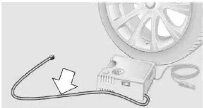 Illustration of a car tire connected to an electrical device with a cable, showing a downward arrow (no text or symbols)
