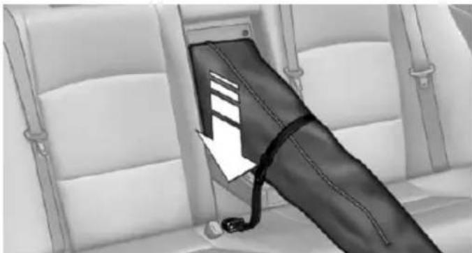 Interior view of a vehicle seatbelt with a black belt and cable inserted, showing no text or symbols